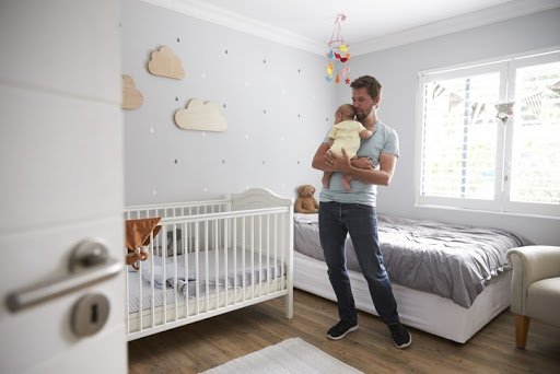 father holds baby